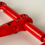 Heavy-duty ratchet load binder used for securing chains on trailer cargo, featuring a steel construction and ratcheting handle for tightening and safely tensioning loads during transport.