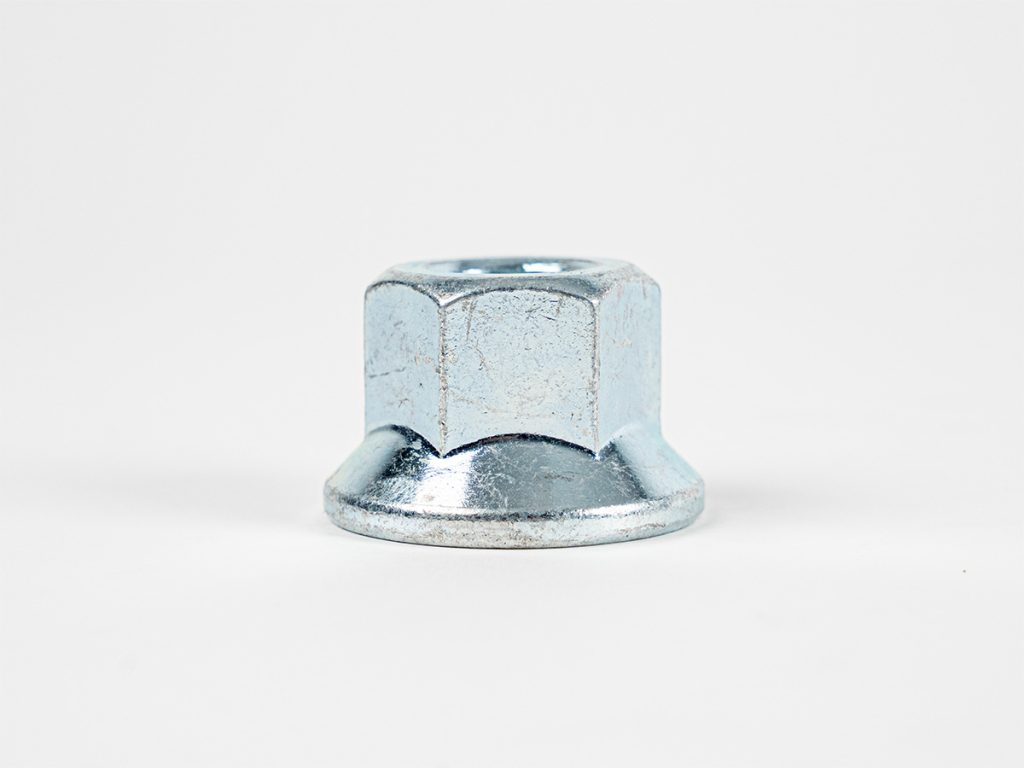 Close-up product image of a zinc-plated trailer wheel flange nut with a hexagonal design, shown against a white background.