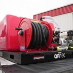 150-gallon fire suppression truck skid mounted in a pickup truck bed, equipped with water tank, pump system, and hose reel for wildfire response