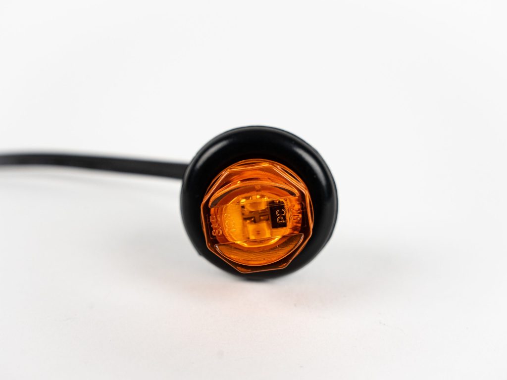 Front of Yellow (amber) 3/4 Inch 2-LED Grommet Mount Marker Light with wiring coming in.