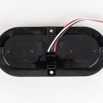 Bottom of grommet for Red 6 inch Oval 10-LED Surface Mount Tail Light. Showing 3-wire electrical connection.