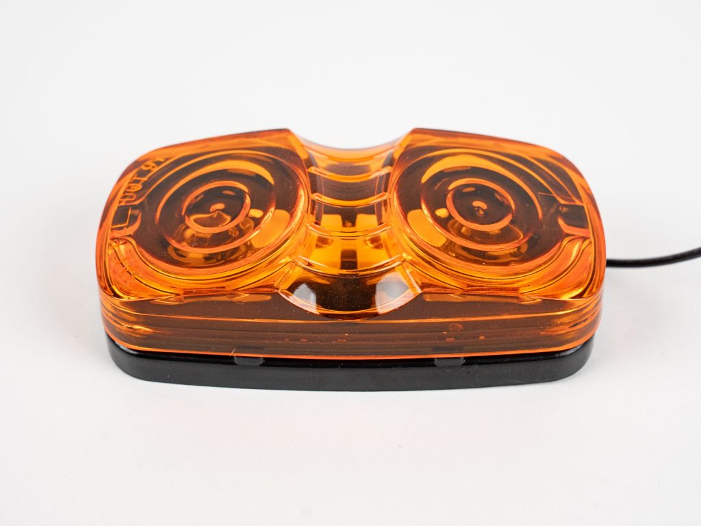 Bullseye Marker Light MC42AB surface mount with yellow (amber) lens. Showing single electrical wire. Also works as clearance light.