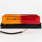Side view of Dual Red/Yellow Thinline 10-LED Surface Mount Fender Light Kit on mount with electrical wire and connector.