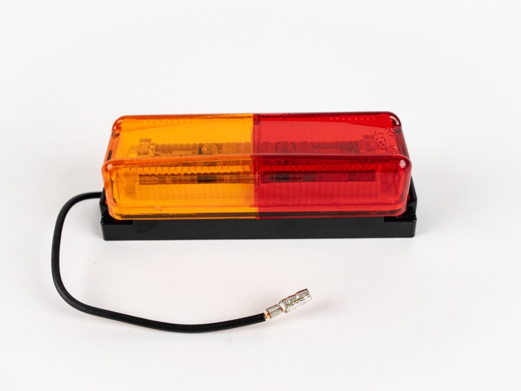 Dual Red/Yellow Thinline 10-LED Surface Mount Fender Light Kit on mount with electrical wire and connector.