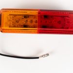 Top of Dual Red/Yellow Thinline 10-LED Surface Mount Fender Light Kit on mount with electrical wire and connector.