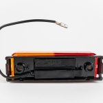 Bottom of Dual Red/Yellow Thinline 10-LED Surface Mount Fender Light Kit on mount with electrical wire and connector.