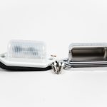 Oblong 2-LED License Plate Light with ABS housing, polycarbonate lens, 2 wires, mounting hardware, chrome cover & mount.