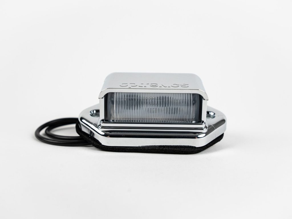 Oblong 2-LED License Plate Light with chrome ABS housing, polycarbonate lens, 2 wires, chrome cover & mount.