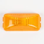 Amber plastic vehicle marker light cover stamped with "SAE PC" against a white background.