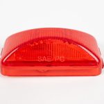 Red plastic vehicle marker light cover stamped with "SAE PC" against a white background.
