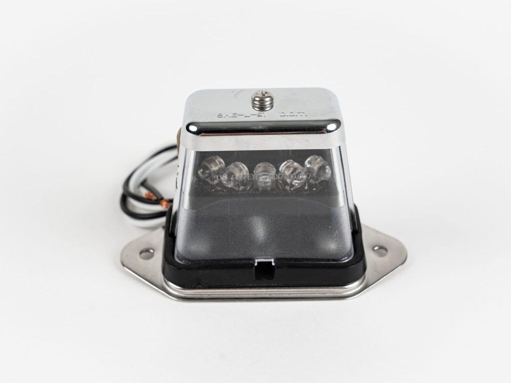 Rectangle 5-LED License Plate Light, showing clear housing, lens, & 5 white light emitting diodes.