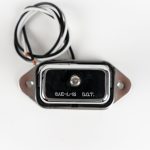 Front of Rectangle 5-LED License Plate Light, showing chrome cover, white ground wire and black power wire.