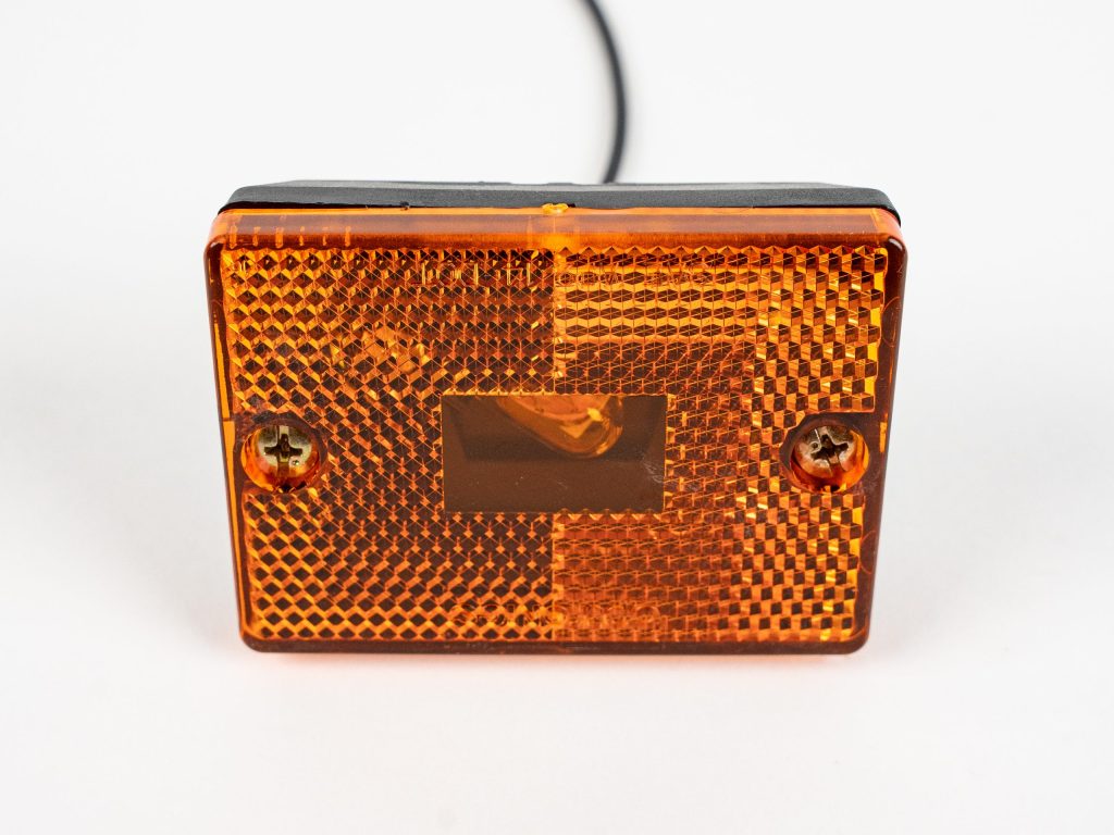 Amber Rectangle Stud Mounted Marker Light MC36AB, showing incandescent bulb, 2-screw lens and single power wire. Mounts on trailer as side marker or clearance light.