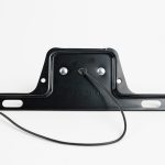 Top of Round Mini License Plate Light with Steel Bracket, & single black power wire..