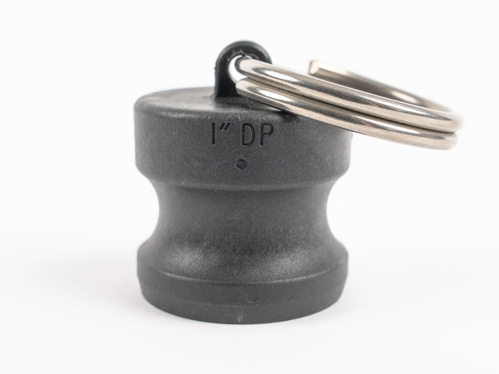 Black polypropylene 1" camlock dust plug with attached metal split ring key ring.