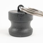 Black polypropylene 1" camlock dust plug with attached metal split ring key ring.